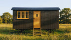 18ft sheperd hut with corrugated metal and oak door